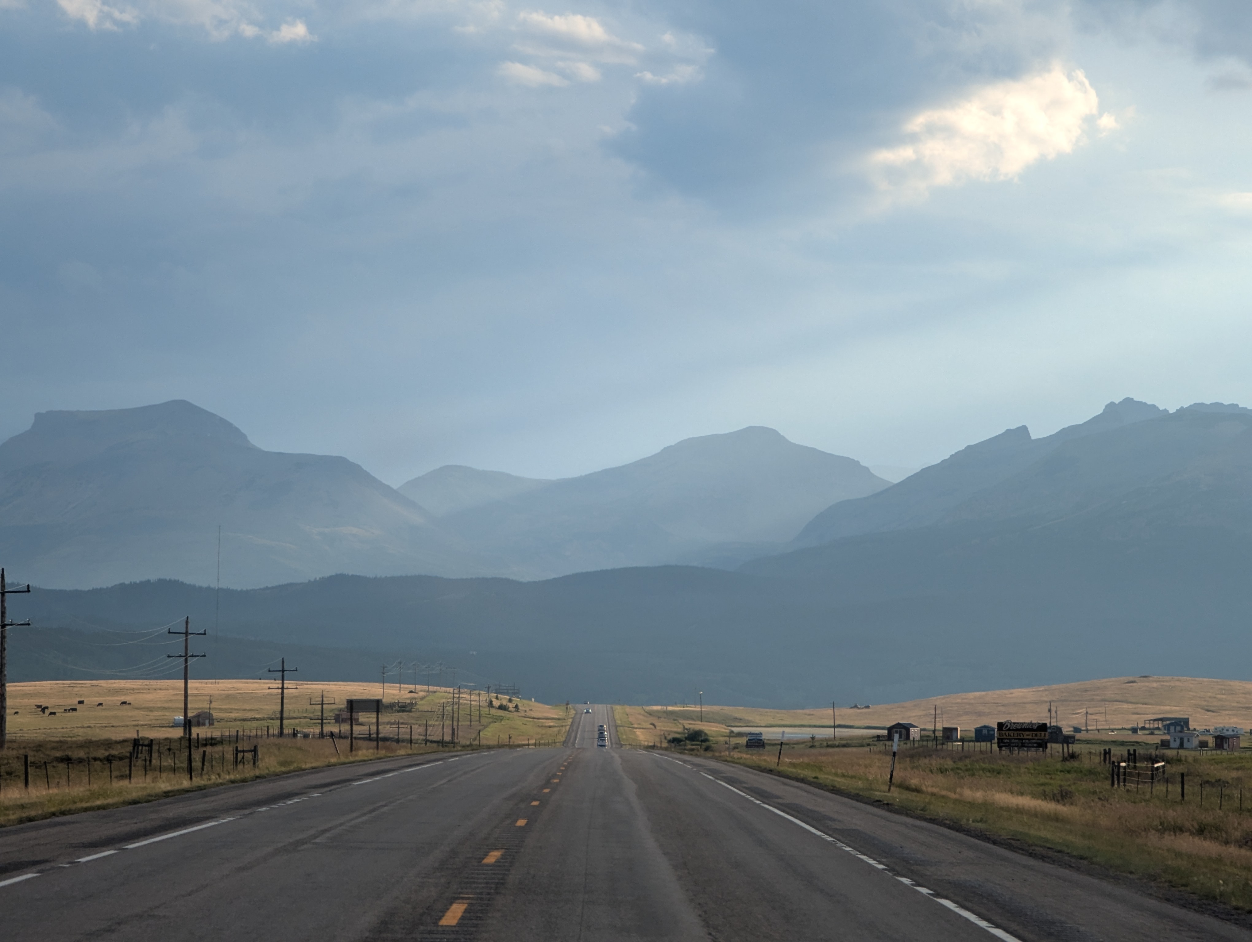 Driving on a rural road towards the mountains